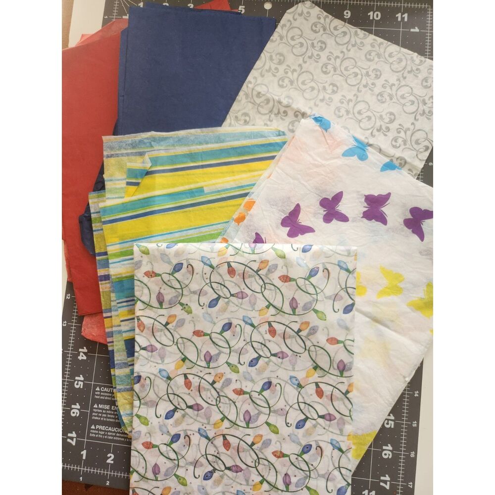 a stack of colorful tissue paper pieces B25
